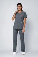 Model wearing Smoky Grey ST247 Scrub Top by Good Uniform, full front view