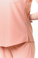 Side slit and seam details on the Coral Peach CST202 Scrub Top