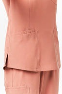 Pocket and side slit details on the Coral Peach CST203 Scrub Top