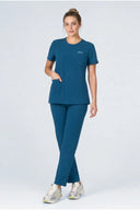 Model wearing Blue Green Mild280 Zip Scrub Top by Good Uniform, full front view