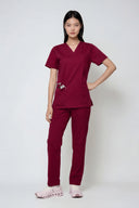 Model wearing Rosé Wine Avison Scrub Top by Good Uniform, full front view